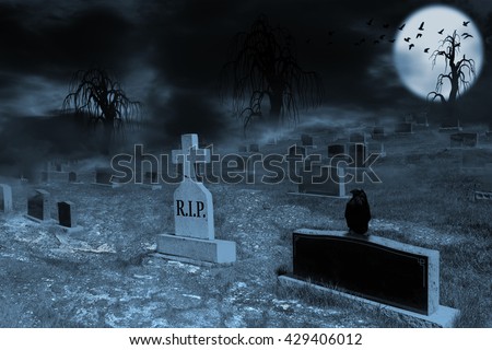 Graveyard on a supermoon-lit night with tombstones, dark clouds, fog and spooky trees. Crow sitting on a foreground tombstone with silhouette of ravens flying in the backlit moon in background.