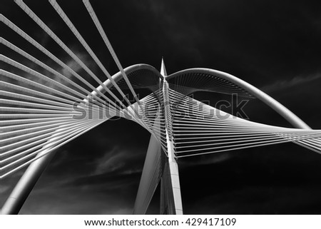 Elasticity of the bridge's string and the futuristic architecture ( black and white ) Royalty-Free Stock Photo #429417109