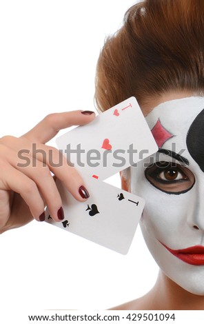 Girl in image of joker with cards in studio shoot
