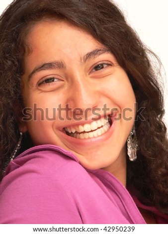 A close-up shot of the face of a pretty young girl with long dark hair for white background an nice smiling.
