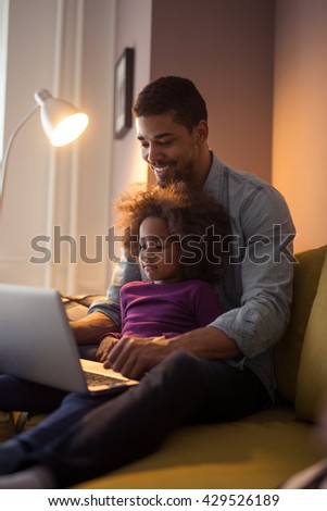 Dad and his cute girl using computer together.