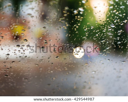Drops Of Rain On Blue Glass Background. Street Bokeh Lights Out Of Focus. Abstract Backdrop