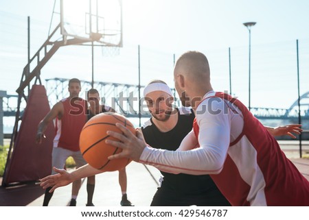 A young basketball player prepares to dribble a ball.