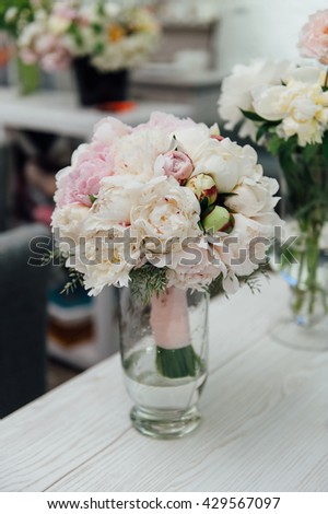 flowers of colored peonies on a wooden table