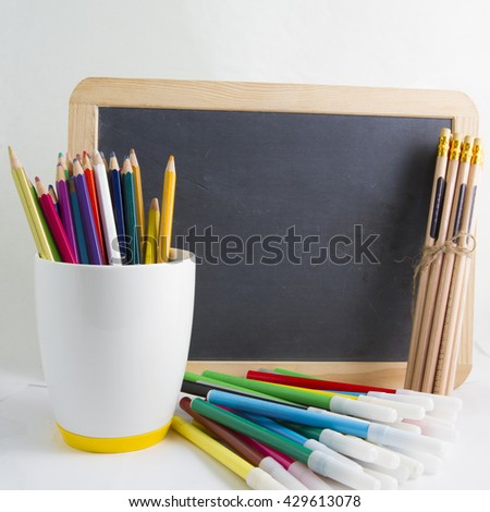 pencils color and black board ,back to school supplies closeup