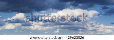High resolution blue sky panorama with white and dark stormy  clouds background 