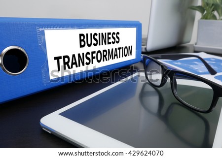 BUSINESS TRANSFORMATION Office folder on Desktop on table with Office Supplies. ipad