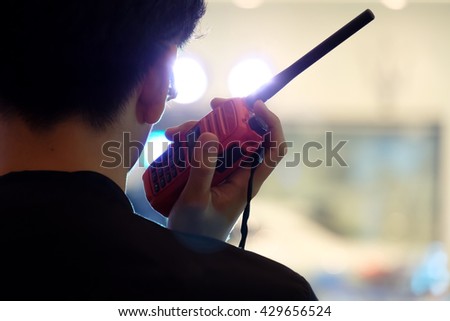 Man with a Walkie Talkie or Portable radio transceiver for communication Royalty-Free Stock Photo #429656524