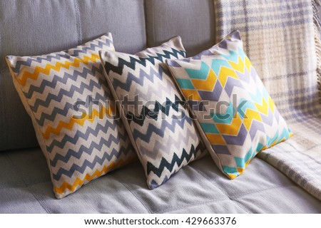 Cushions on sofa, indoors Royalty-Free Stock Photo #429663376