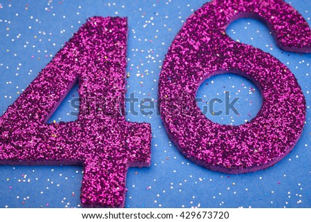 Number fortysix purple color over a blue background. Anniversary. Horizontal