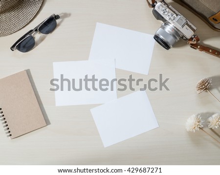 Top view of Travel and vacation photo frames and items, camera, sunglasses, notebook on wooden table on the wooden background ( Composition and space for text )