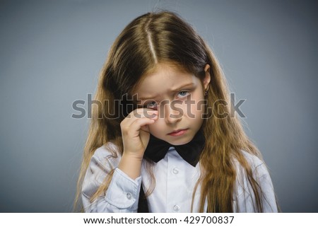 Portrait of offense crying girl isolated on gray background. Negative human emotion, facial expression. Closeup