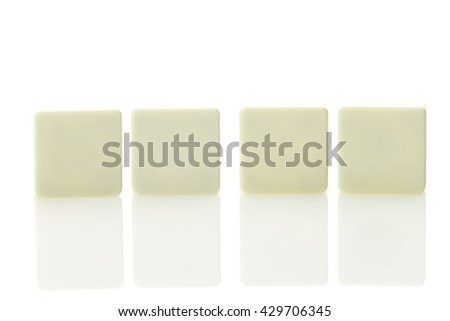 Four blank plastic tile pieces for text in a row, isolated on a white background