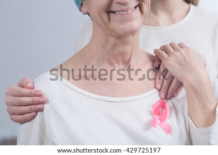 Cropped picture of a sick woman wearing a pink ribbon