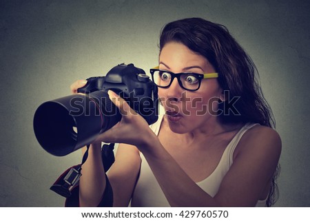Closeup excited shocked woman with professional DSLR camera isolated on gray wall background 