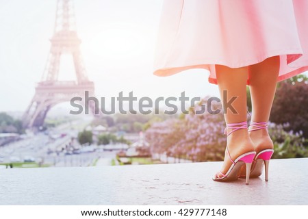 beautiful fashion woman on high heels near Eiffel tower in Paris, France