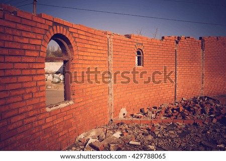Arched windows without glass in a brick wall
