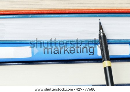 - marketing- business concept message on the photo holder with stationary and textbook background. 