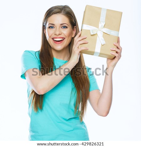 Happy woman holding gift box. Smiling girl with long hair.