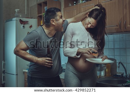 Alcoholic husband grabbed hair and shouts pregnant wife. Social problems of the family.