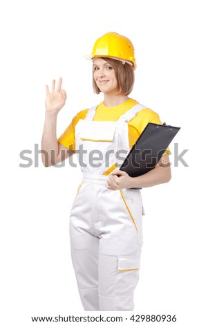 smiling female painter or decorator with clipboard showing an okay sign isolated on white background. proposing service. advertisement gesture