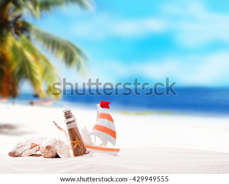 Shells on sandy beach with tropical beach background 