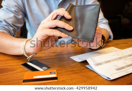 credit card debt - pour empty wallet. Royalty-Free Stock Photo #429958942