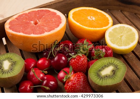Fresh fruits on color wooden background