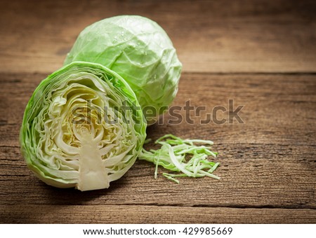 cabbage and cutted cabbage on wooden Royalty-Free Stock Photo #429985669