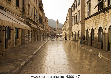 The Stradun (sometimes the Strada) is the main shopping street and gathering area in the city of Dubrovnik in Croatia. The cobblestones have been polished smooth over hundreds of years. Royalty-Free Stock Photo #4300147