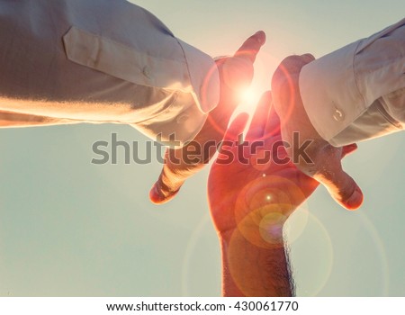 high five threesome in the sun! yes, we can. motivate your employees. Royalty-Free Stock Photo #430061770