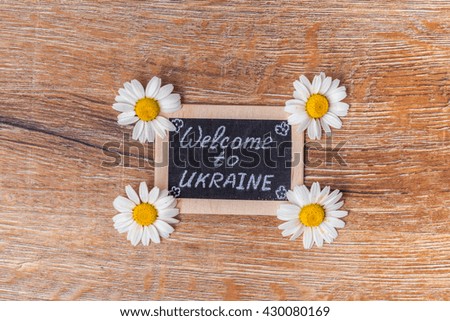 flowers and card on the old wooden background