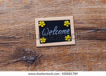 Old tag and flowers on the wooden background