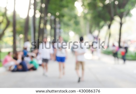 Abstract blurred background walking on footpath in the public park, city background, people activity background