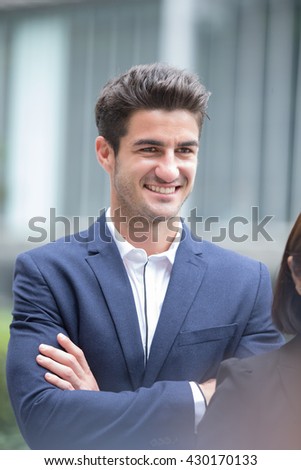 Business man smile with business office building background, caucasian, shot in Hong Kong