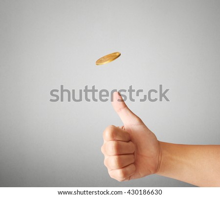 hand throwing up a coin to make  decision 