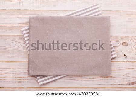 Napkin. Cloth napkin on white wooden background. Top view, mockup.
