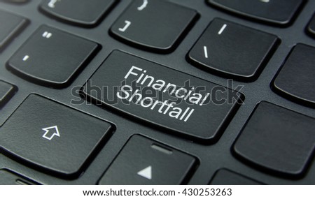 Business Concept: Close-up the Financial Shortfall button on the keyboard and have Black color button isolate black keyboard