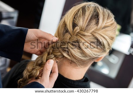 Closeup Of Hairstylist's Hands Braiding Client's Hair Royalty-Free Stock Photo #430267798