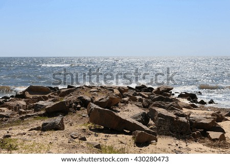 Rock seacoast with blue sea on background