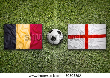 Belgium vs. England flags on a green soccer field Royalty-Free Stock Photo #430305862