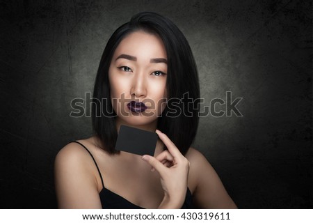 Asian woman hold black empty card