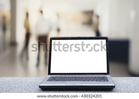 Focus laptop on marble table.Blur abstract background of employees meeting in conference room.Blurry view of people meet in meeting room.