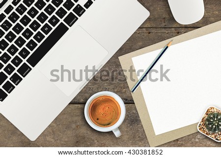 office supplies and gadgets on old wooden table background [view from above]