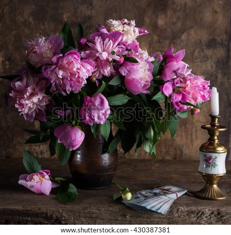 Beautiful bouquet of pink peonies and  pack of dollars on a wooden background