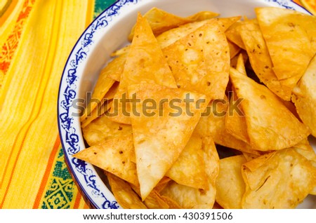 Bowl of crunchy delicous tortilla chips sitting on native american table cloth