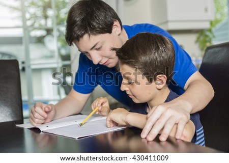 A Big brother trains the younger brother Royalty-Free Stock Photo #430411009