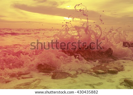 vintage color of sea waves plashing over rocks