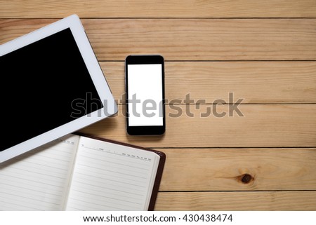 Office stuff with  blank screen tablet, blank screen smart phone and leather notebook top view with workspace.Flat lay image