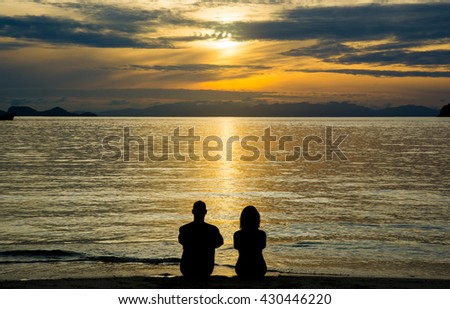 Lovers on the beach at sunrise